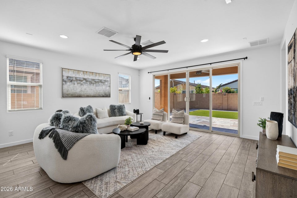Living room with oversized sliders opening to the backyard